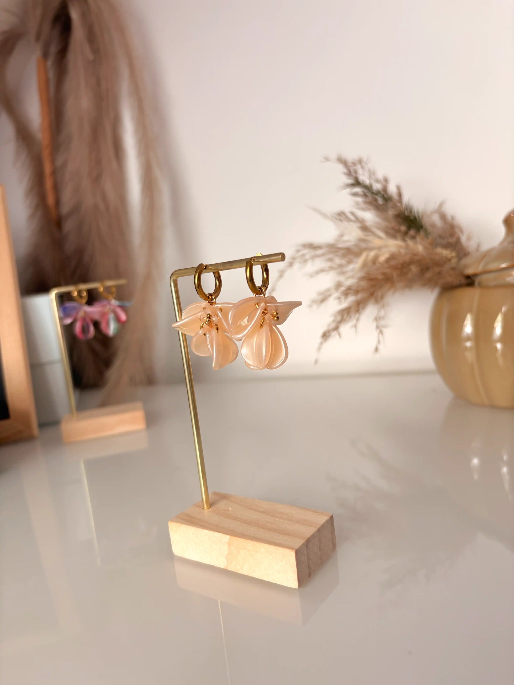 boucles d'oreilles mini-créoles en acier inoxydable doré et présentées sur un support métallique doré et bambou. Bijoux ornés de pétales sequins nude marbré et perles de verre.